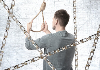 Man with rope noose and metal chains, back view