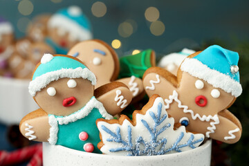 Delicious homemade Christmas cookies in bowl against blurred festive lights, closeup