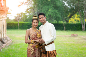 Thai couple wear Thai traditional wedding dress at ancient place. wedding ceremony, asian thai ceremony, thailand culture and romantic couples concept.