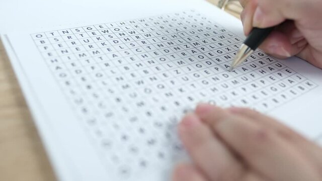 female hand close-up draws lines on paper, spell out and spell word temperature in square, concept of brain development in old age, therapeutic health support, preventive fight against senile dementia