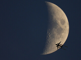 Fly me to the moon - airplane flying towards the moon