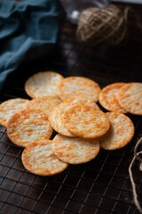 Crispy crackers on a black circle, black top view.