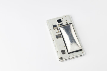 Cell phone battery swelling due to expiration. damaged swollen battery of mobile phone. Defective mobile phone battery.