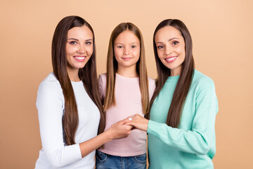 Photo of cheerful positive family woman hold hands care harmony isolated on pastel beige color background