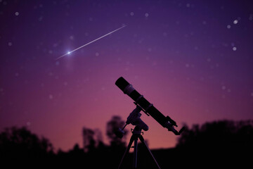 Silhouette of telescope and countryside under the starry skies.