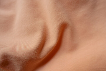 Rumpled apricot colored simple cotton jersey fabric