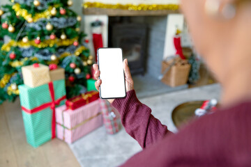 Caucasian woman using smartphone with copy space at christmas time