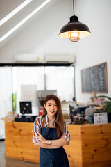 Portrait of Startup successful small business owner in coffee shop.woman barista cafe owner. SME entrepreneur seller business concept	