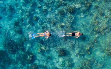 The people are snorkeling near the famous place on Gili Meno Island, Indonesia. Aerial view. Underwater tourism in the ocean. Gili Meno Island, Indonesia. Travel - image - obrazy, fototapety, plakaty