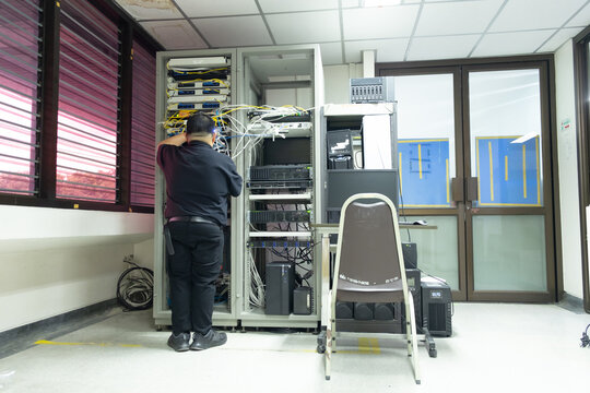 The system administrator works in the server room of the data center..