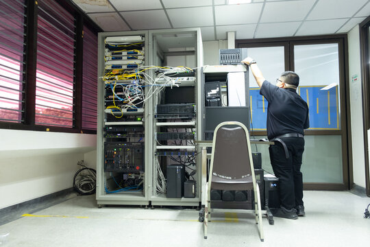 The system administrator works in the server room of the data center..