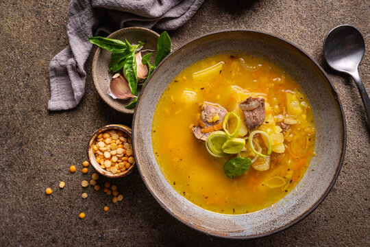 Bowl of split pea soup with chunks of ham and meat, top view