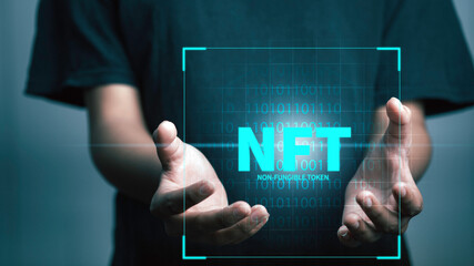 NFT non fungible tokens concept. Businessman holding digital unique art NFT hologram on digital