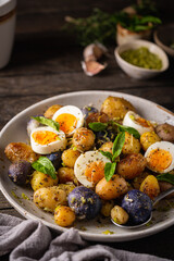 Homemade salad of new colorful potatoes, quail eggs and pesto