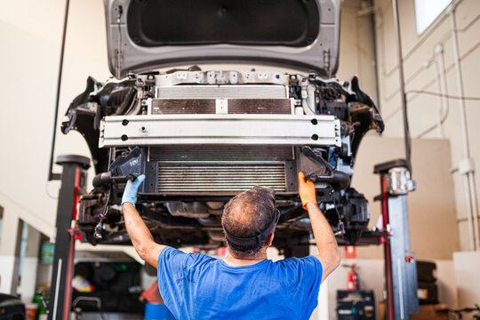 Mechanic repairing car in workshop