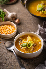 Closeup of a bowl of split pea soup with chunks of ham and meat
