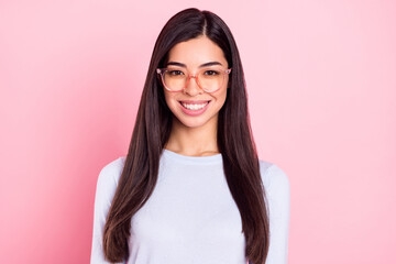 Portrait of attractive content cheerful girl wearing specs isolated over pink pastel color...