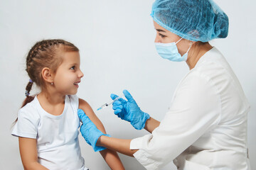 Female doctor injecting vaccine to girl