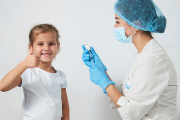 Female doctor injecting vaccine to girl