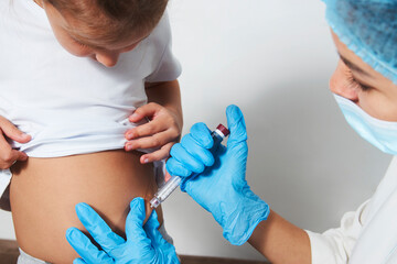 Girl getting insulin by female doctor
