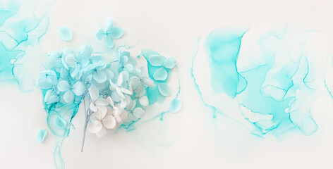 Creative image of pastel blue and pink Hydrangea flowers on artistic ink background. Top view with copy space