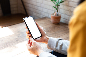 cell phone blank white screen mockup.woman hand holding texting using mobile on desk at office.background empty space for advertise.work people contact marketing business,technology