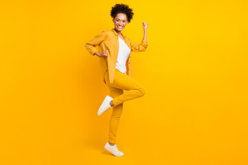 Fototapeta na wymiar Full body profile side photo of young excited african girl celebrate victory achievements isolated over yellow color background