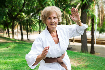 Mature lady in kimono exercising outdoors