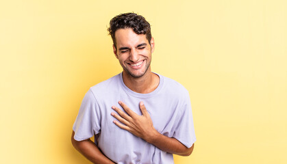 hispanic handsome man laughing out loud at some hilarious joke