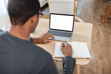 African American man Freelancer using laptop while working at home.