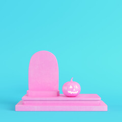 Pink halloween pumpkin with gravestone on bright blue background in pastel colors