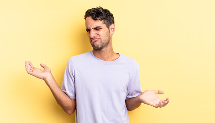 hispanic handsome man looking puzzled, confused and stressed