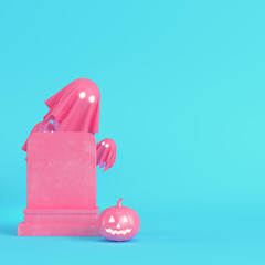 Pink halloween pumpkin with ghosts and gravestone on bright blue background in pastel colors