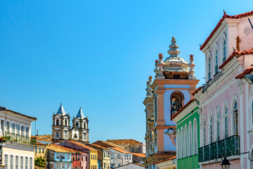 Obraz premium Colorful facades and historic church towers in baroque and colonial style in the famous Pelourinho neighborhood of Salvador, Bahia