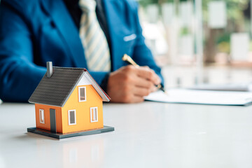 Buying a Home or Insurance, an insurance agent explains the lease agreement to a client before making a contract. Mortgage loan approval home loan and insurance concept.