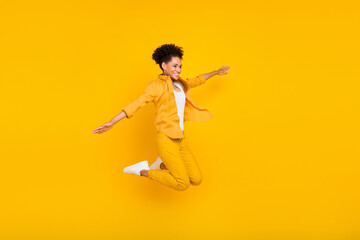 Full length body size photo woman jumping up careless looking copyspace isolated vivid yellow color background