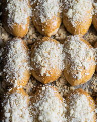 Fresh baked patties russian pirozhki on a baking sheet. Close-up, top view