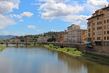 Fototapeta na wymiar FLORENCE, Italy - July 12, 2014: View from the Ponte Vecchio of Florence.