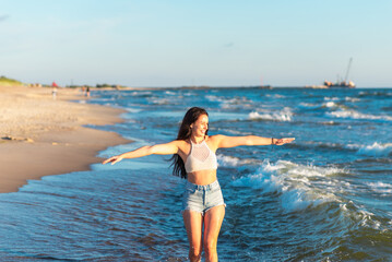 Young woman playing in the sea.woman enjoying in sea water .Cheerful young woman having fun on the summer beach.