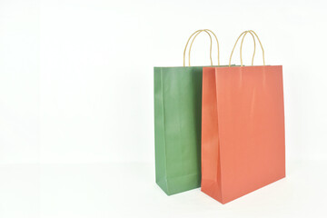 Colorful paper shopping bags on white background with copy space.
