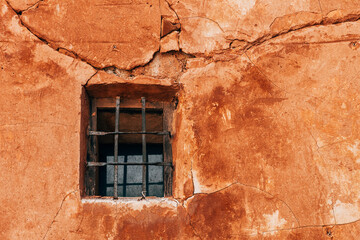 detailed window  frame in a red wall