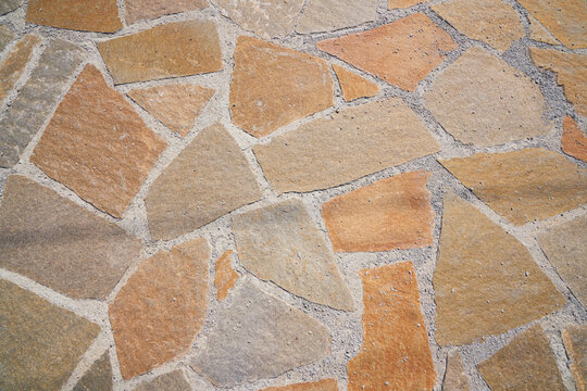 Orange old stone road surface. Seamless Texture. The texture of a stone road. High quality photo