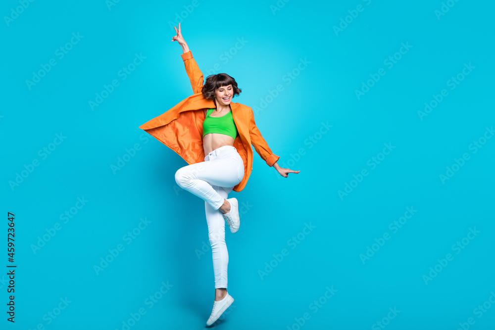 Sticker Full length photo of cheerful cool woman jump up air good mood enjoy smile isolated on blue color background