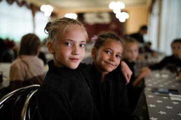 Portrait of smiling girls in canteen in sports camp