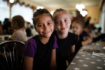 Portrait of smiling girls in canteen in sports camp