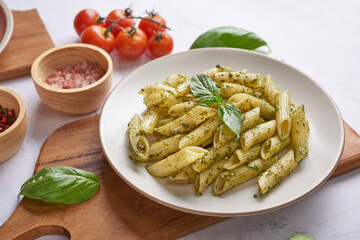 Pasta spaghetti with zucchini, basil, cream and cheese on black stone table. vegetarian vegetable pasta. zucchini noodles. top view copy space. penne pasta with pesto sauce, flat lay.