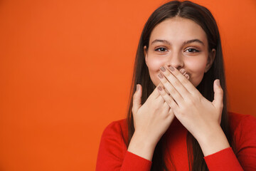 Young white brunette woman smiling and covering her mouth