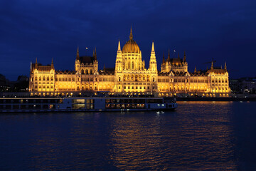 Budapest Parliament building at night on the Danube river in Hungary