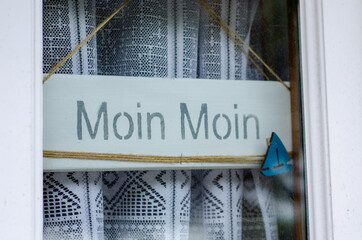 Moin Moin inscription on the plate. Moin means “Hi”, “ Good morning”, “Good night” and...