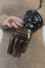 Medieval knightly brown plate gauntlet from Italian armor, in the form of a lion's face and mane,...